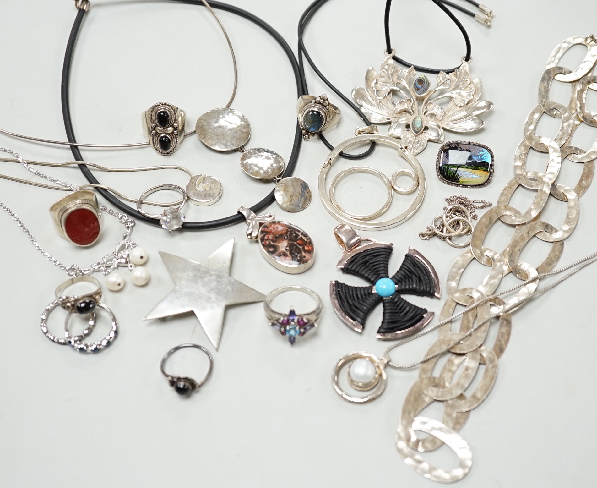 A small collection of 925 and white metal jewellery including a ring link necklace, rings, pendants and brooches etc.
